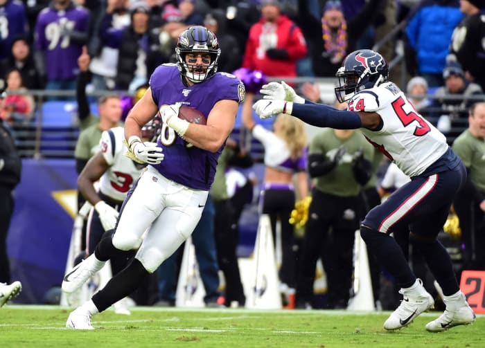 Houston Texans EDGE Jacob Martin tries to tackle Baltimore Ravens TE Mark Andrews